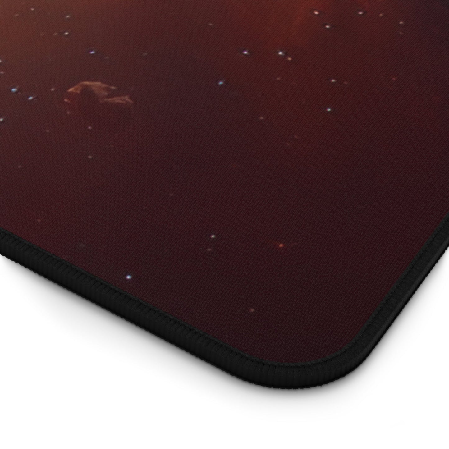 Close-up view of the front of the Vibrant Orange Galactic Print xxl mouse pad