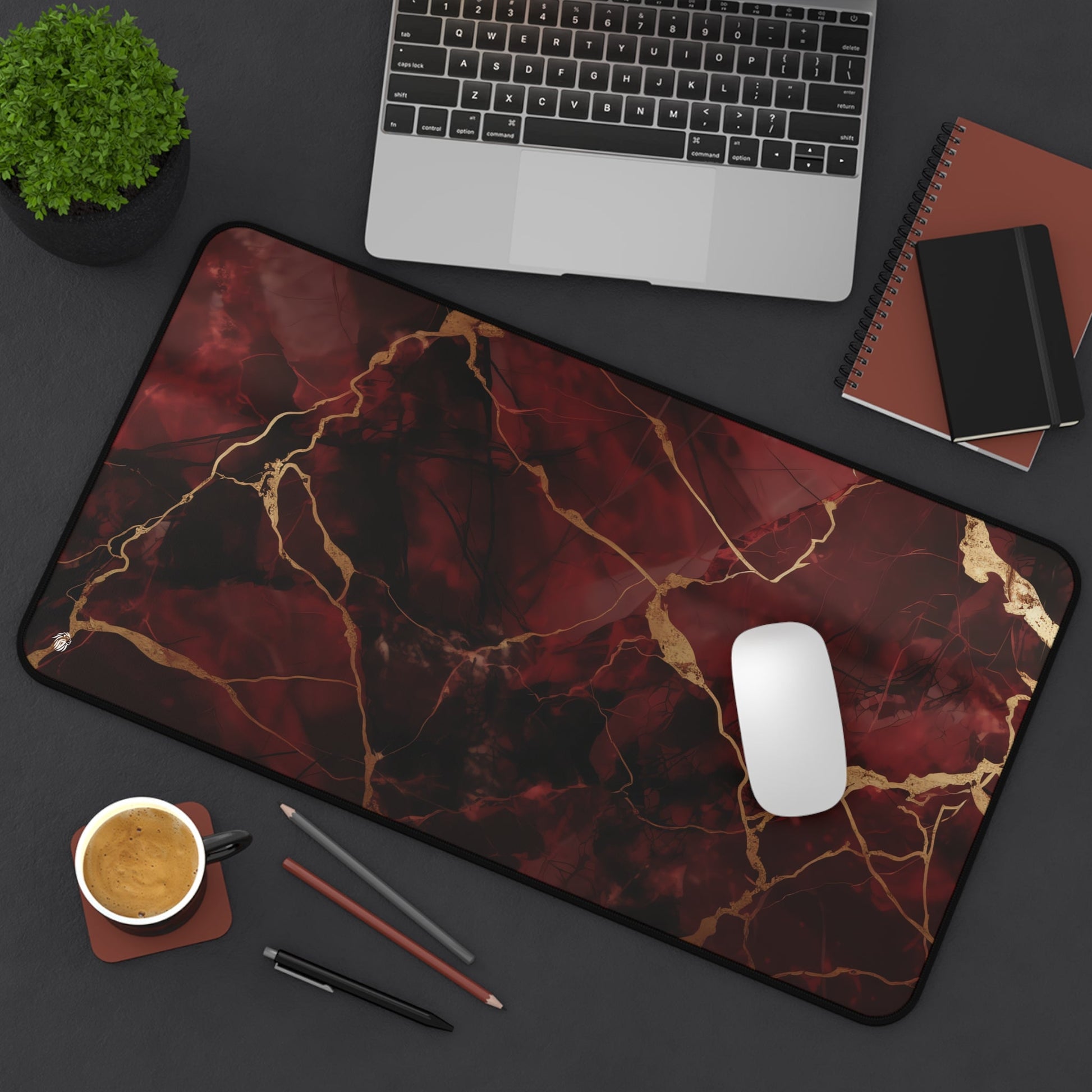 Red Marbled with Gold Streaks xxl mouse pad of size 12 by 22 inches displayed on a desk