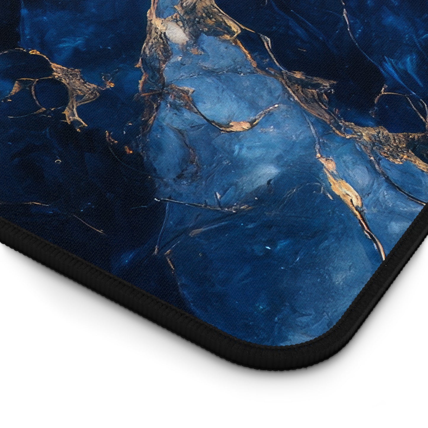 Close-up view of the front of the Blue, Marbled, Gold Accents xxl mouse pad